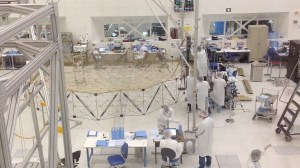 Technicians assembling the SMAP probe in the clean room at JPL.